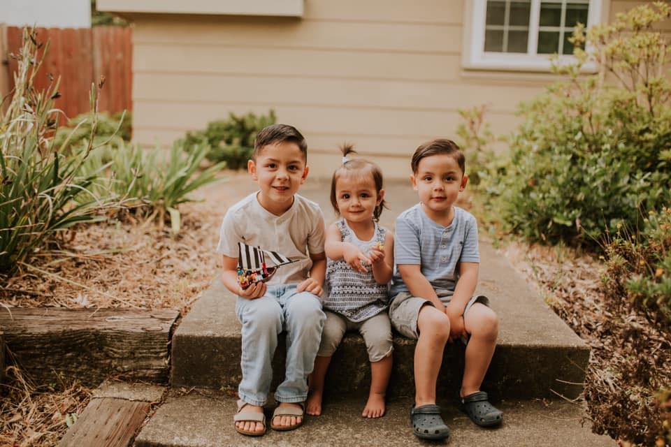 My grandkids sitting outside waiting to wave to the trash truck driver.