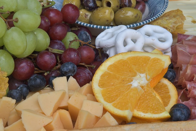 Charcuterie Board full of cheese, olives, lunch meats, and fruits - great for Super Bowl snacks